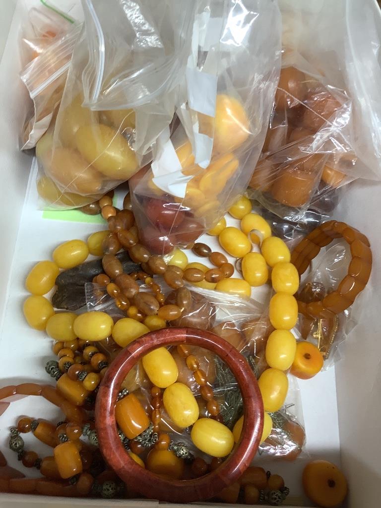 A quantity of assorted amber and faux amber necklaces.